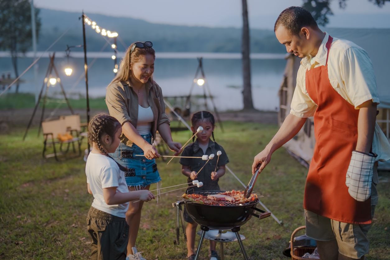 a family grilling and making smores in a park