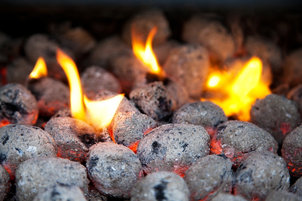 Charcoal briquettes burning in a charcoal grill