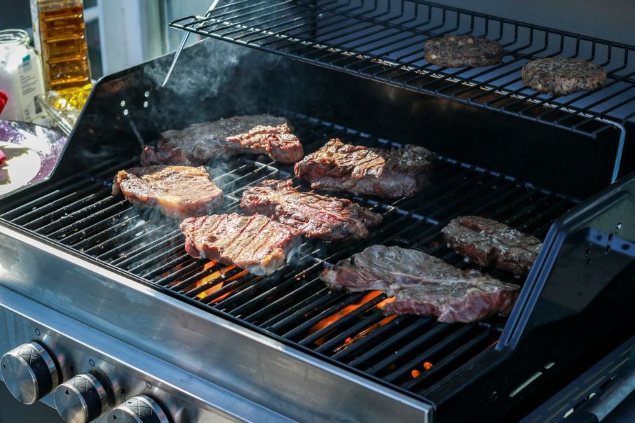A gas grill with cast iron grates