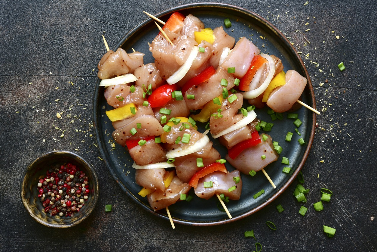 Raw chicken kebab with ingredients for marinating